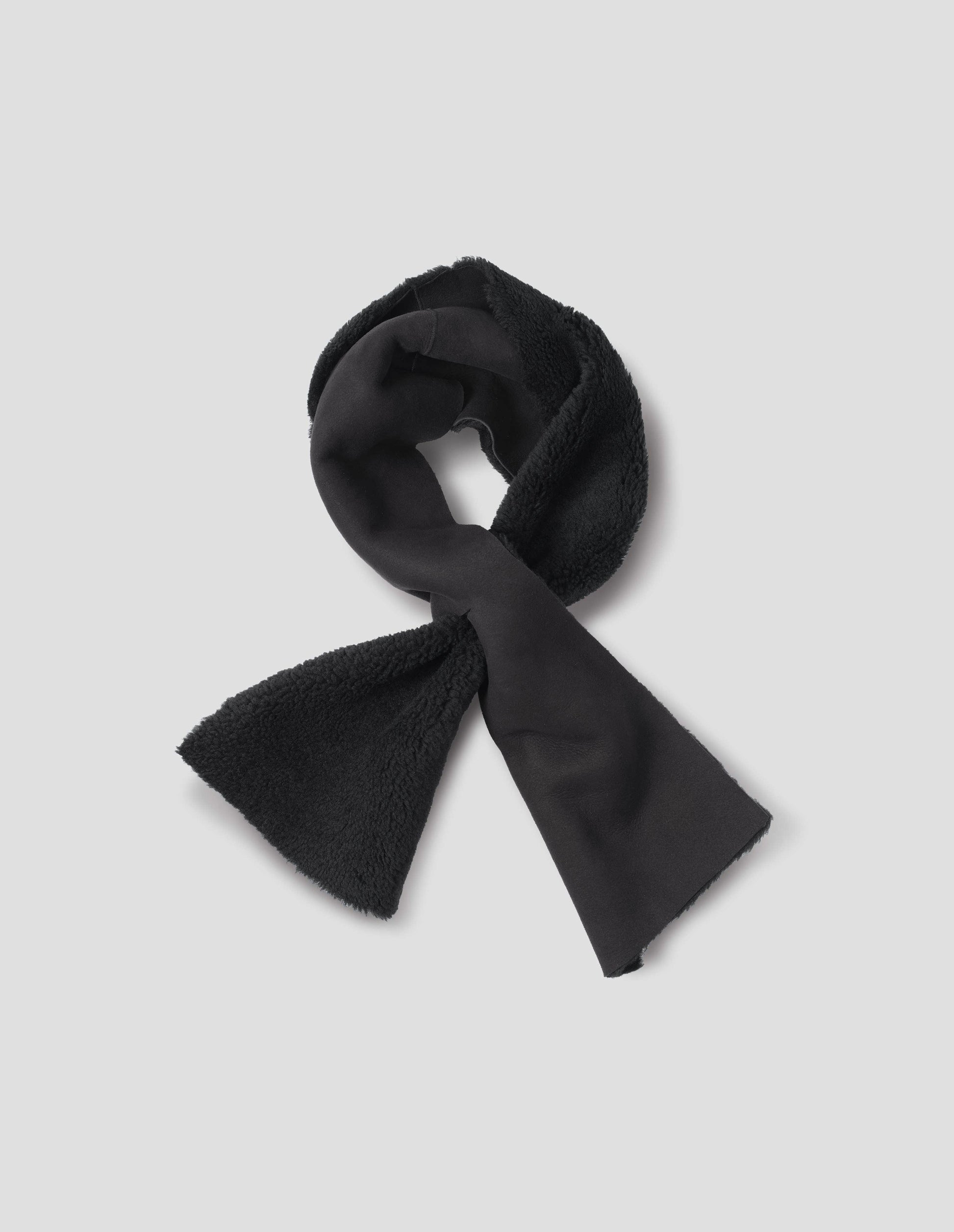 Black shearling tie through scarf with raw edge. Front flat lay view. 