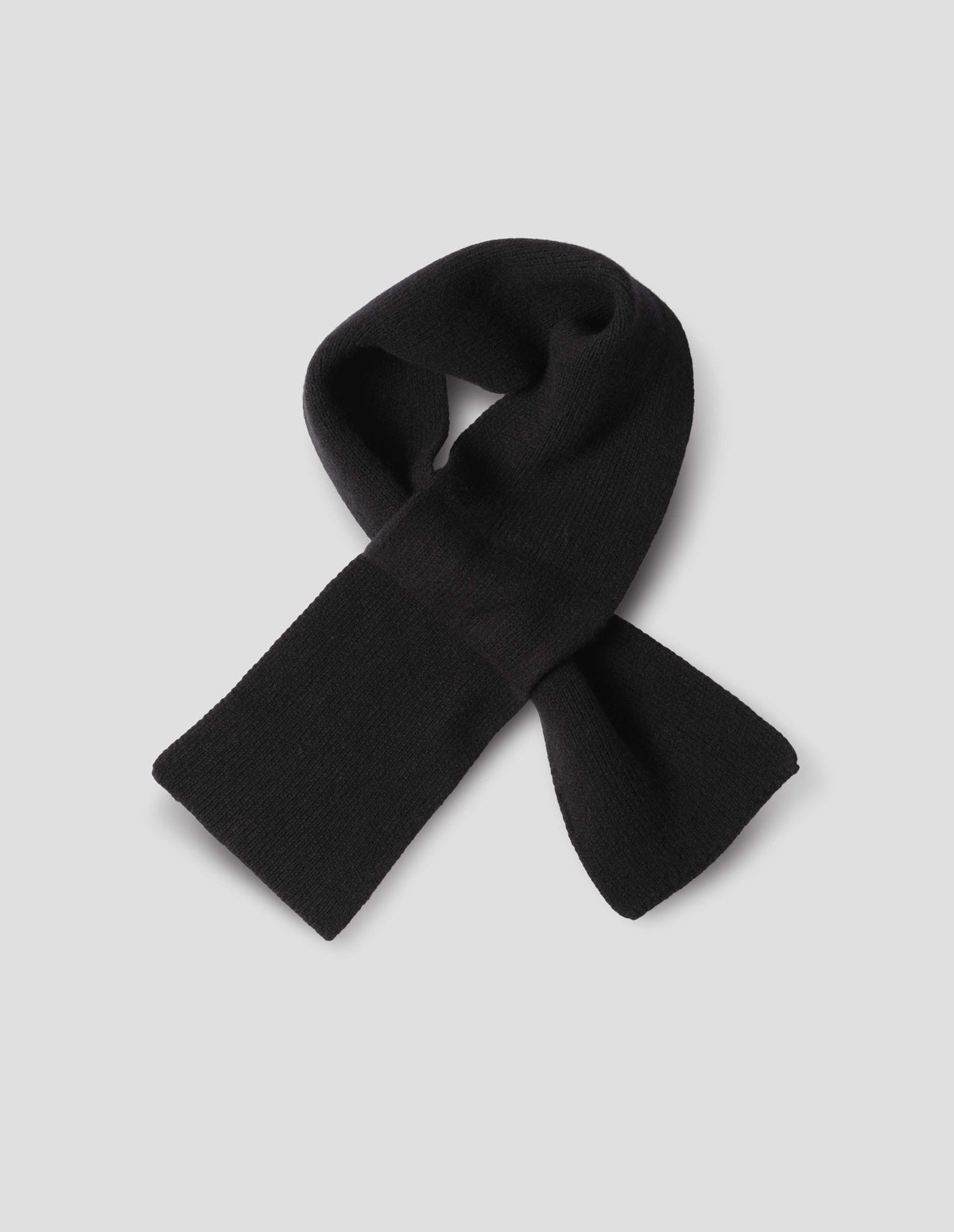 Black cashmere merino tie through knitted scarf. Front flat lay view.