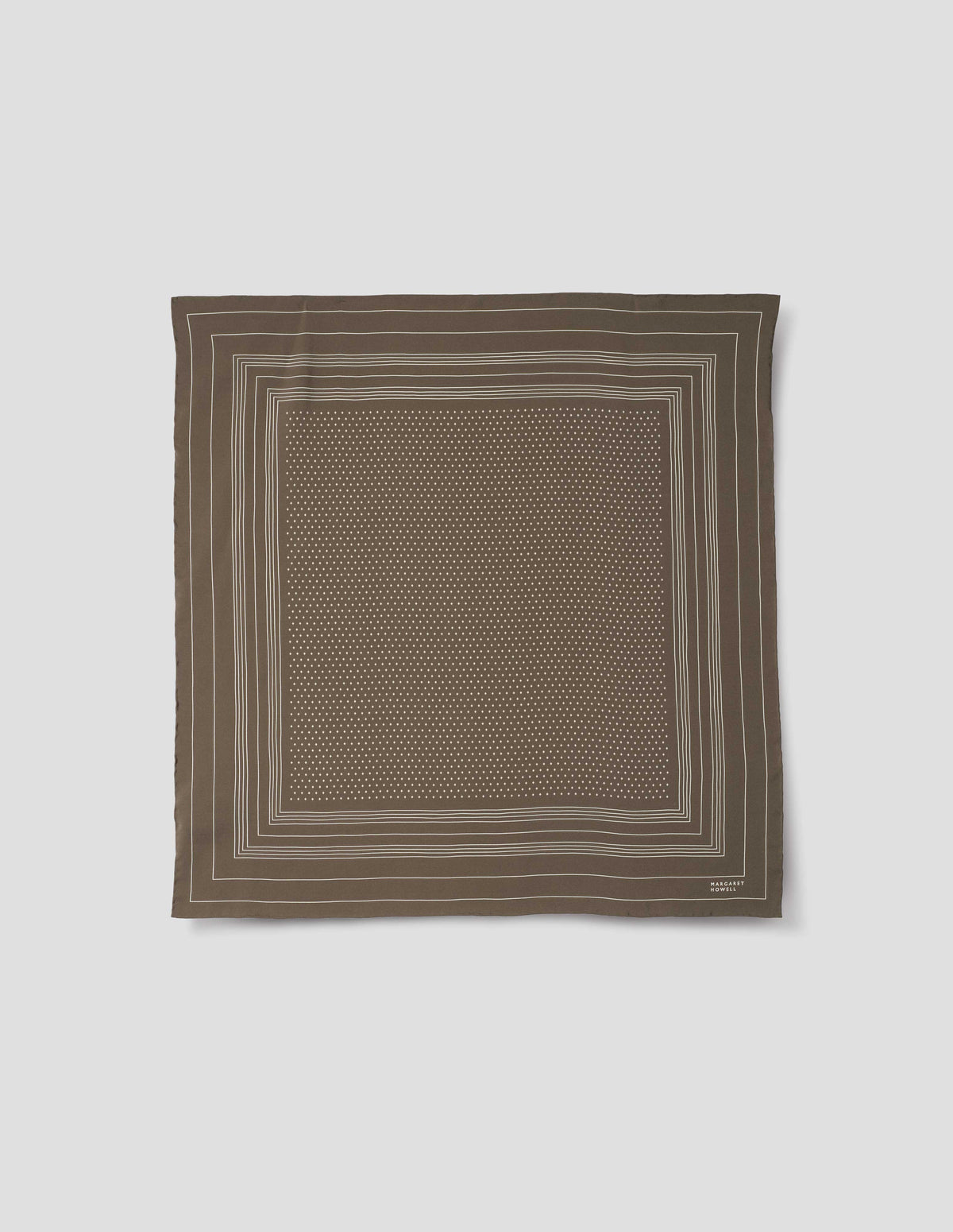 Khaki green square silk neck scarf with white border stripes with white dots inside, hand rolled edges and white Margaret Howell logo in right corner. Front flat lay view.