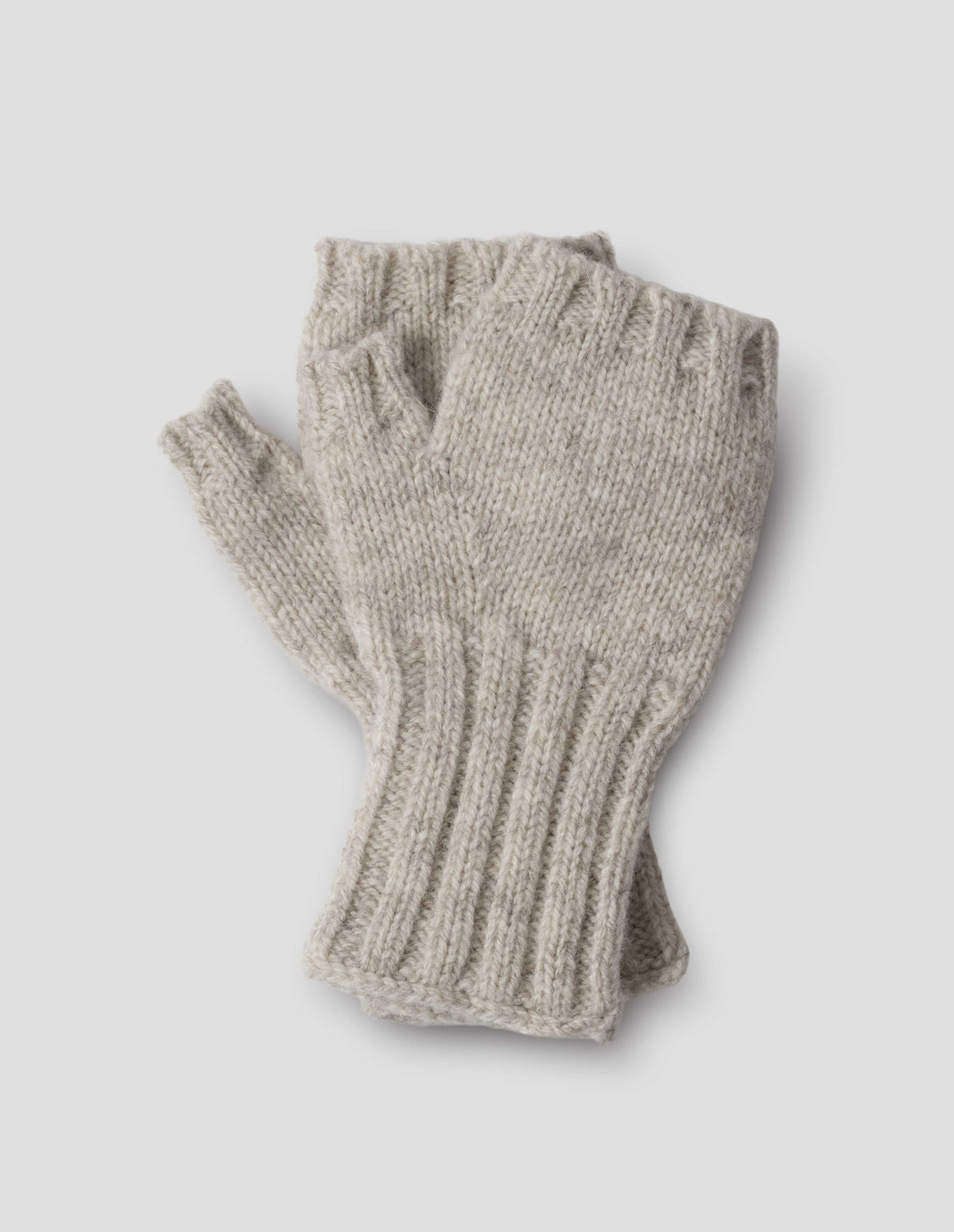 Beige knitted Shetland wool fingerless gloves with contrasting rib cuffs, front flat lay view.