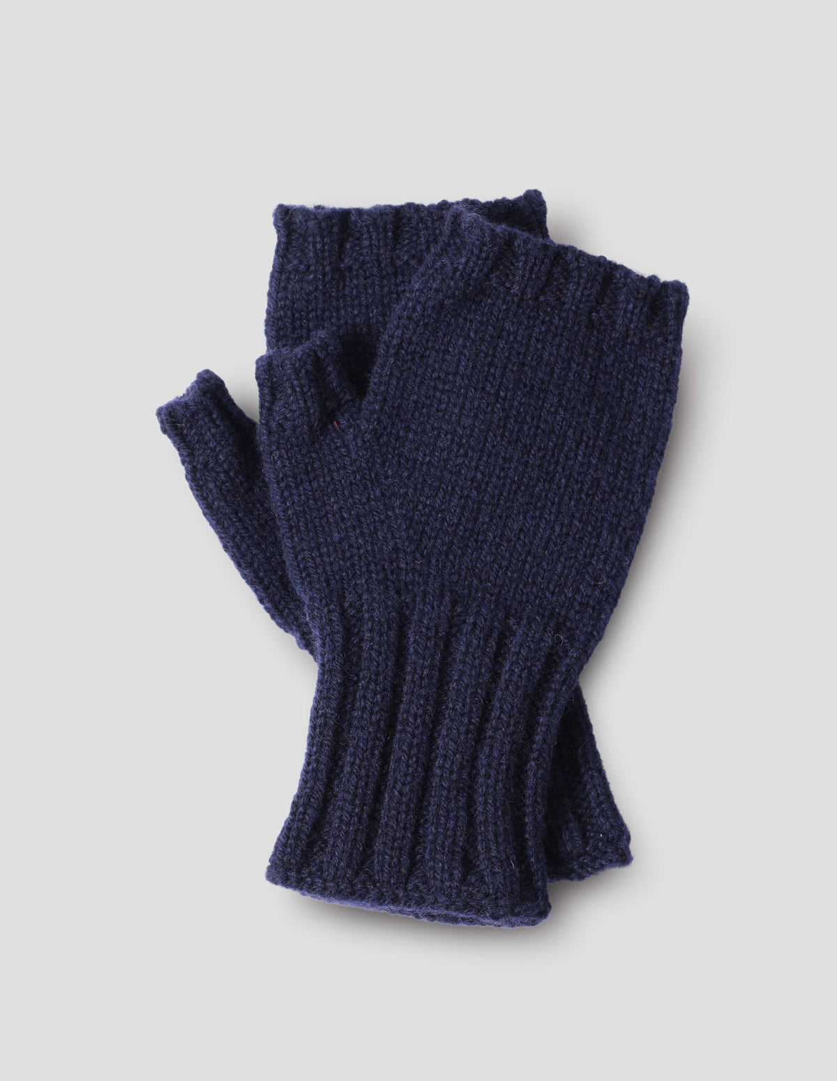 Dark blue knitted Shetland wool fingerless gloves with contrasting rib cuffs, front flat lay view.