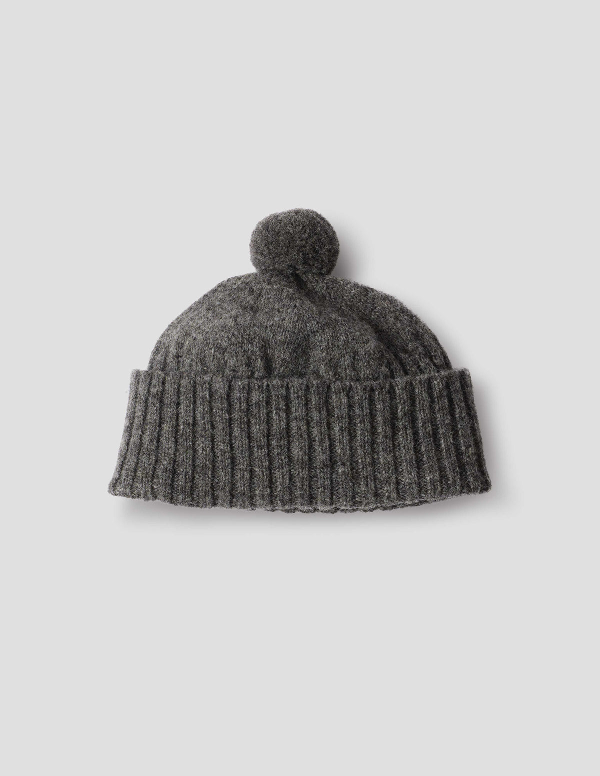 Grey knitted Shetland wool bobble hat with rib turned up cuff, front flat lay view.