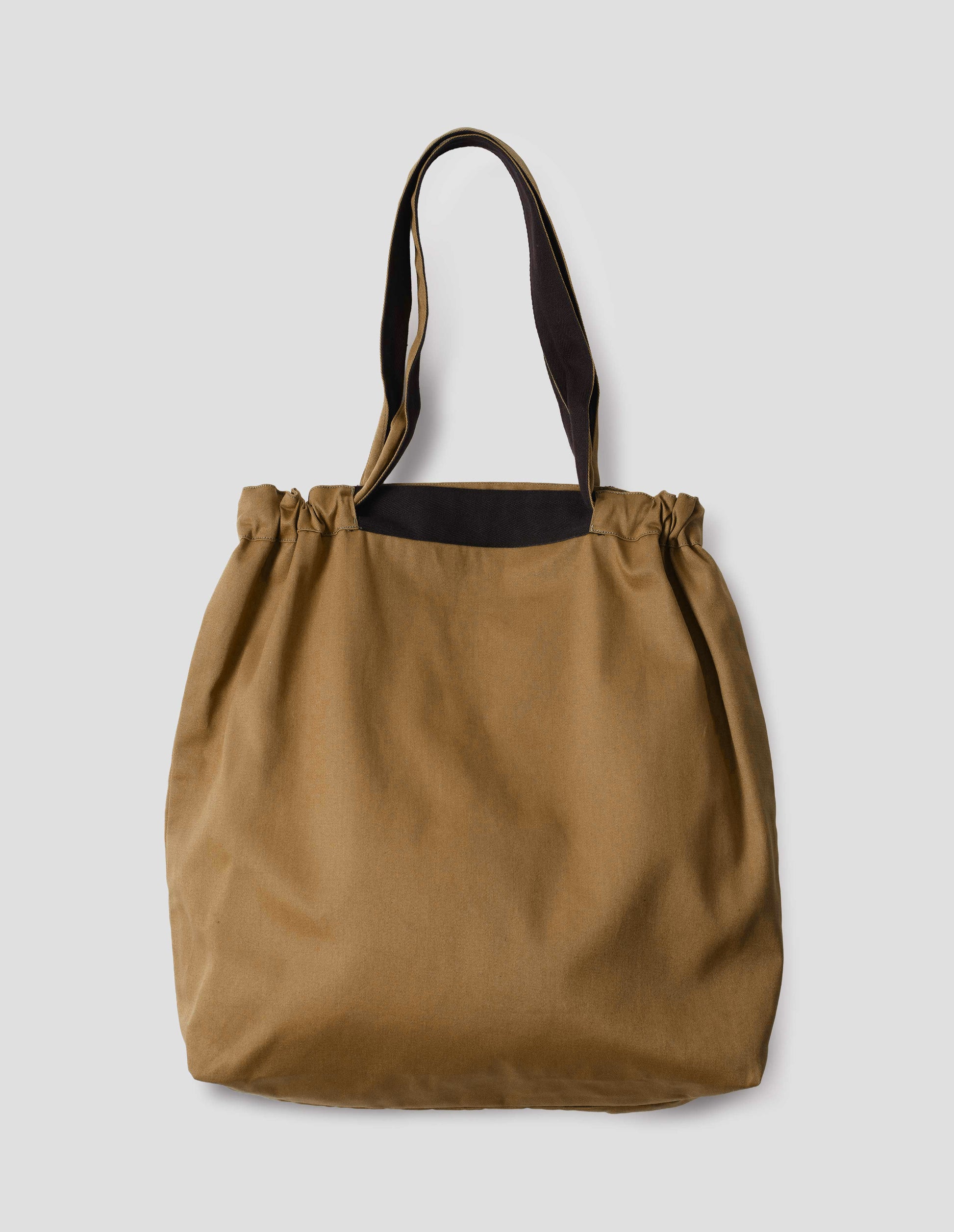 Light brown tote bag with matching drawn up handles and contrasting herringbone tape detailing, back flat lay view.