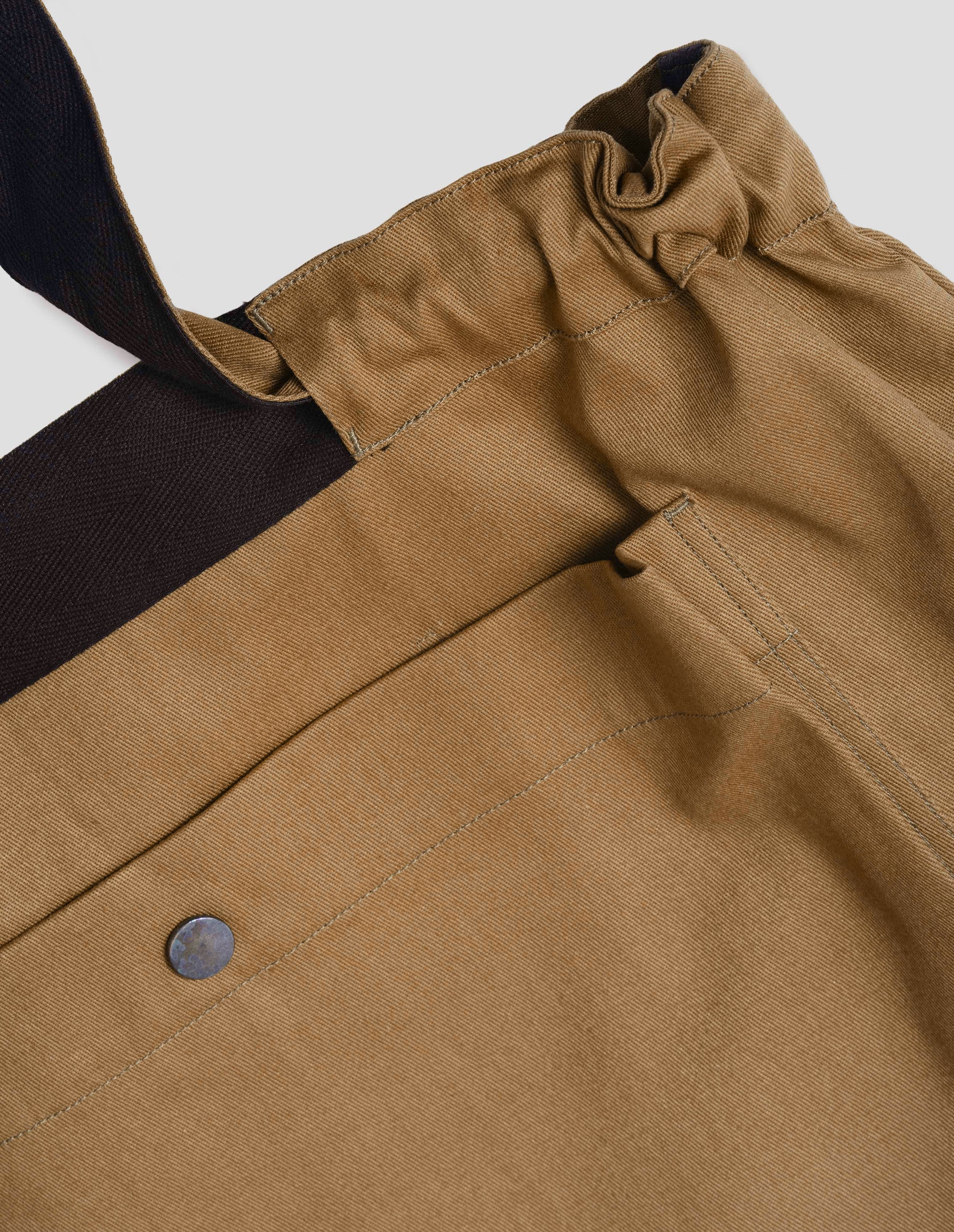 Light brown tote bag and contrasting herringbone tape, fabric swatch.