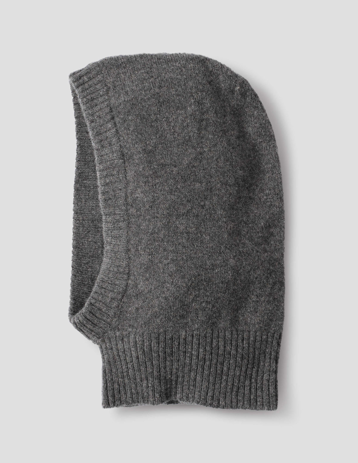 Grey felted knit lambswool hood with contrasting rib on face and neck, side flat lay view.