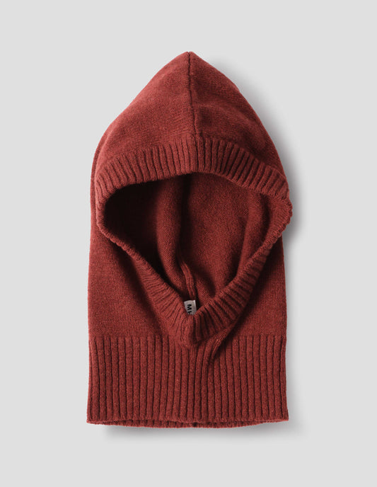 Brownish orange felted knit lambswool hood with contrasting rib on face and neck, front flat lay view.