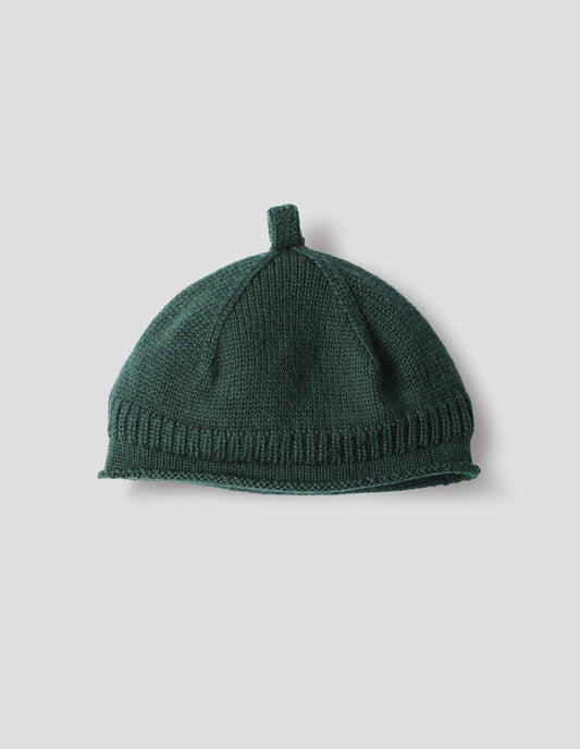 Dark grey merino wool beanie hat with a band of contrasting rib with rolled edge brim and knitted loop detailing on top, front flat lay view.