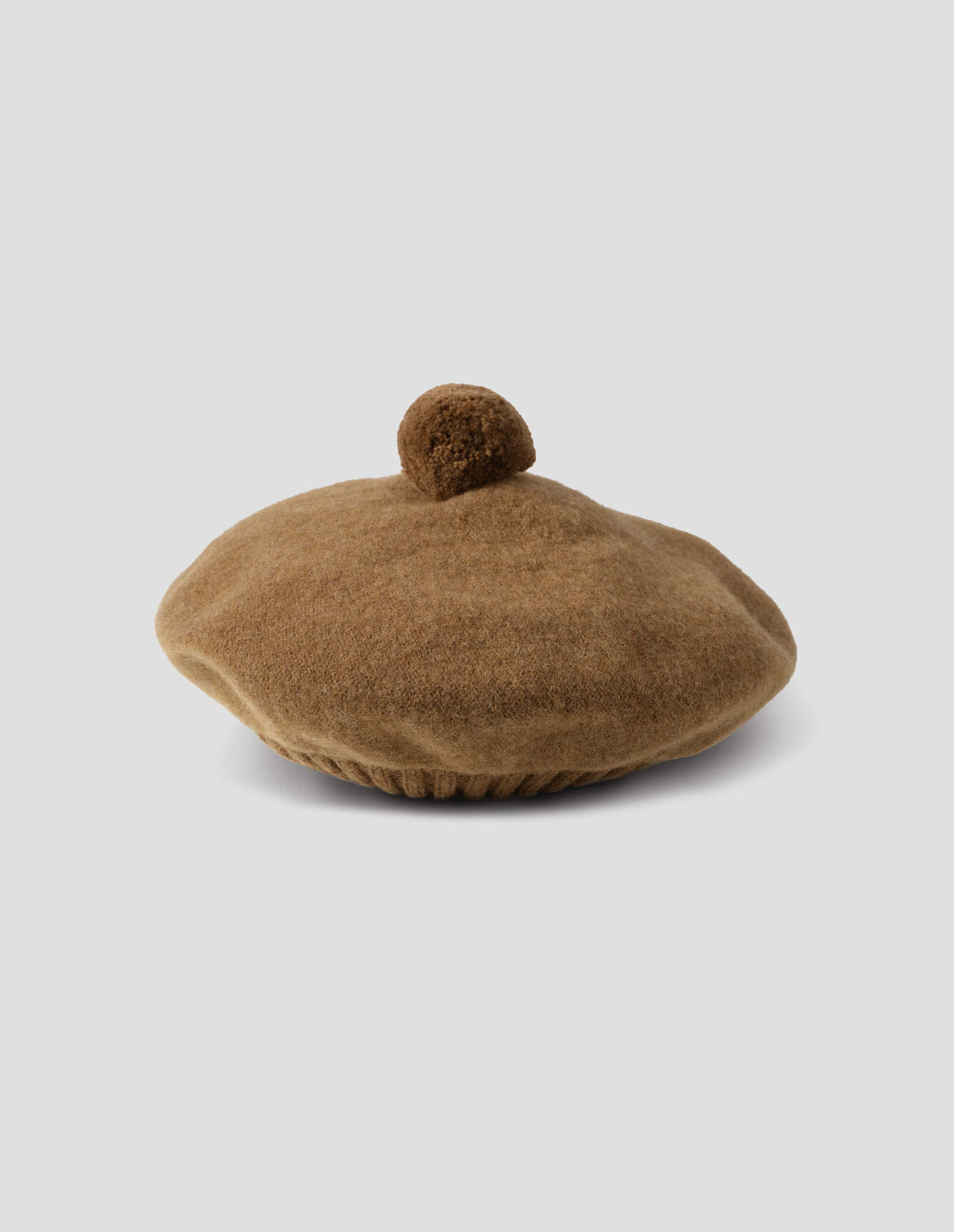 Brown wool tam o shanter hat with matching pom pom in centre, side view.