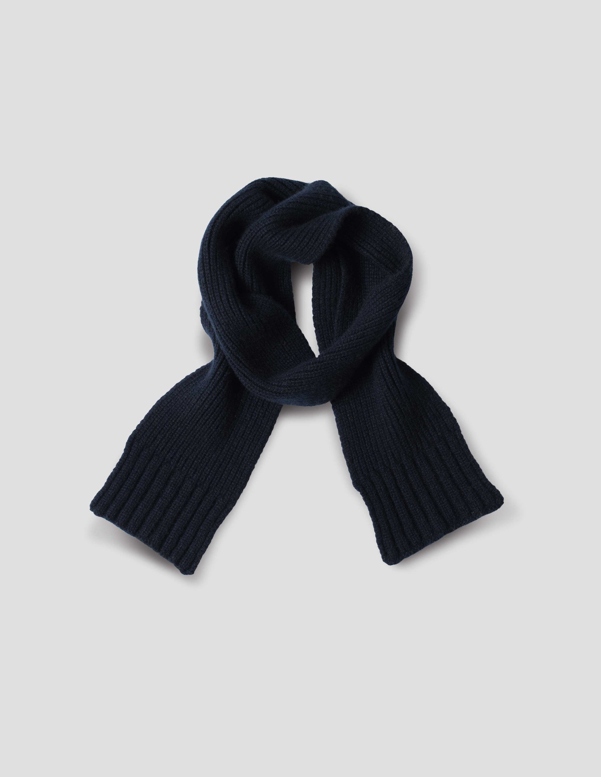 Dark navy knitted ribbed cashmere scarf, front flat lay view.