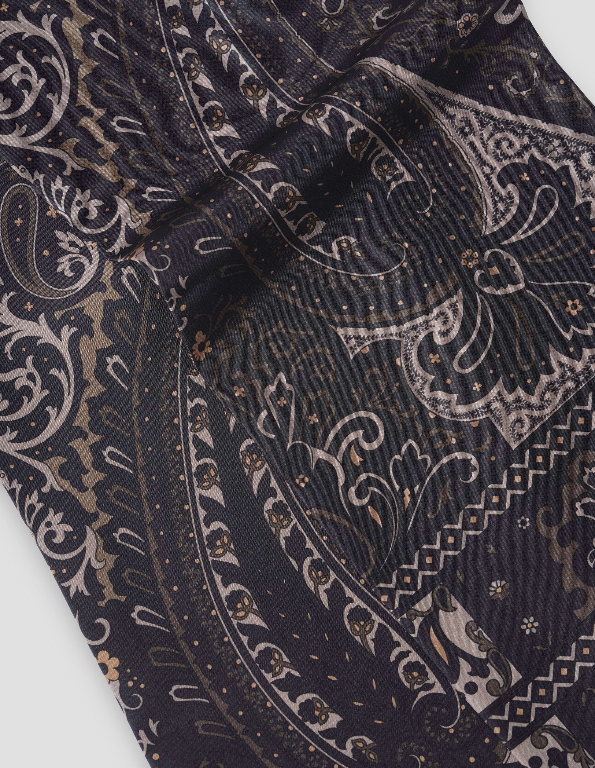 Dark blue silk scarf with light and dark beige paisley print, fabric swatch.