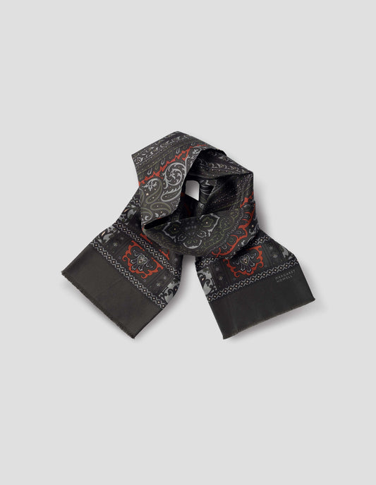 Dark green double sided silk scarf with orange, green and light blue paisley print, frayed edges and contrast Margaret Howell logo. Front flat lay view.
