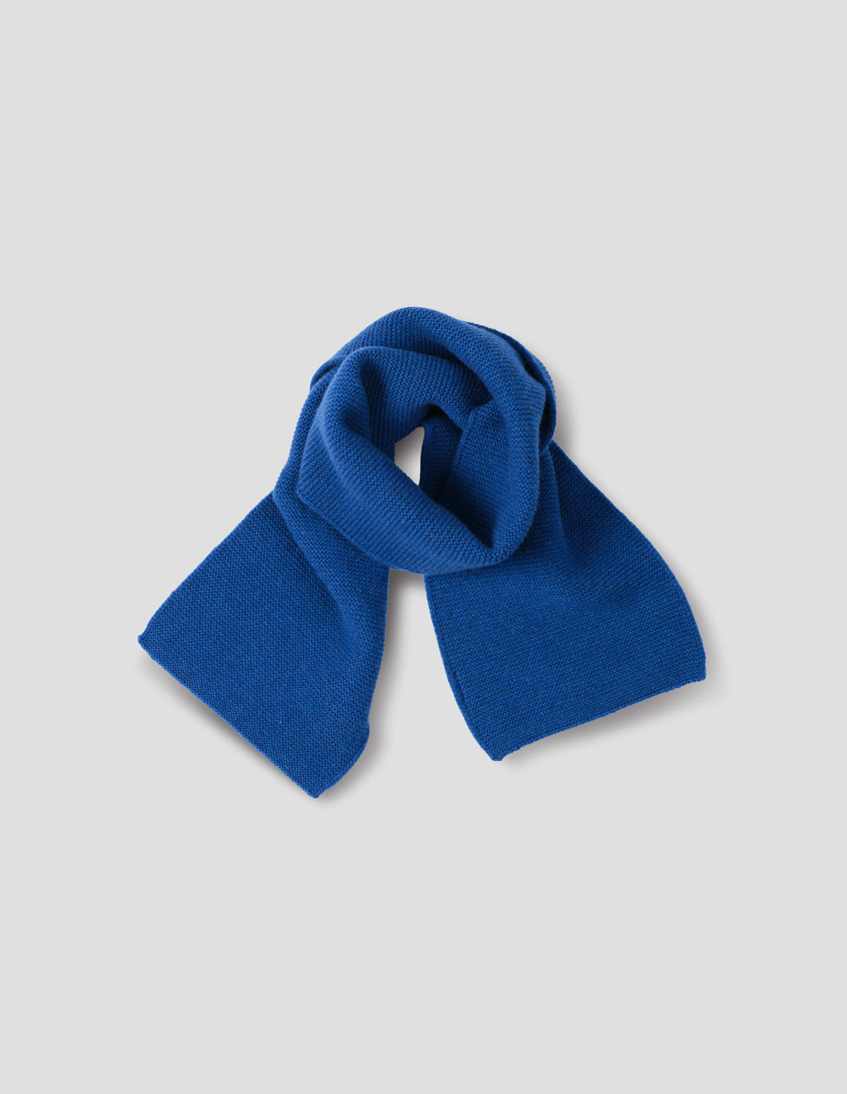 Blue merino cashmere scarf knitted in garter stitch. Front flat lay view.
