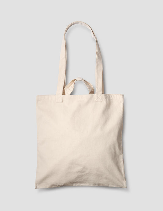 Beige cotton tote bag with shoulder straps and carry handles. Back flat lay view.