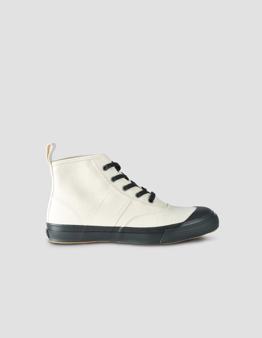 A single off white high top canvas trainer with metal eyelets, contrasting black laces, canvas heel loop and contrasting black rubber sole. Side view flat lay.
