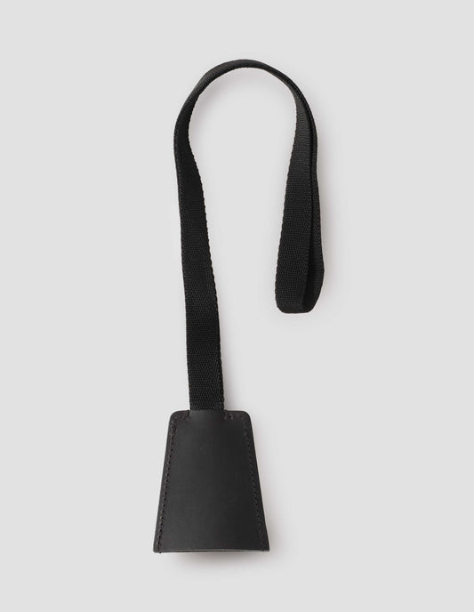 Black full grain leather key holder with contrasting black cotton strap. Back flat lay view.