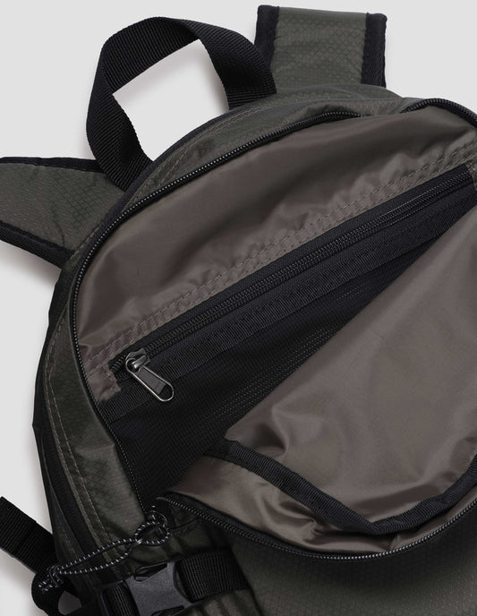 Khaki green nylon ripstop backpack with contrasting black zip closure, contrasting black carry handle and black internal zip pocket. Fabric swatch.