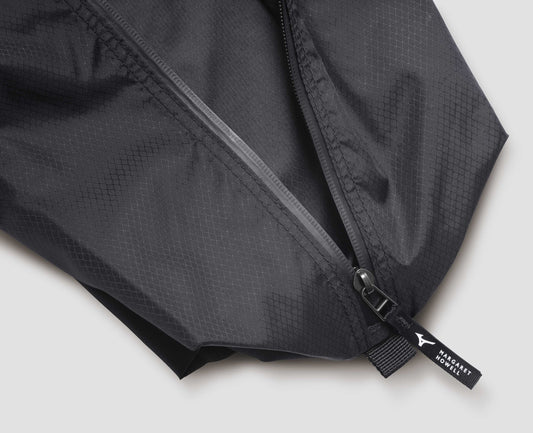 Black nylon ripstop pouch with zip closure with contrasting white Mizuno and Margaret Howell logo on pull tab. Fabric swatch.