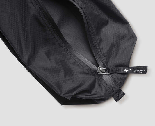 Black nylon ripstop pouch with zip closure with contrasting white Mizuno and Margaret Howell logo on pull tab. Fabric swatch.