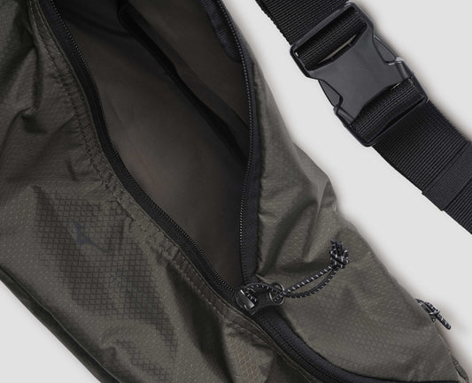 Khaki green nylon ripstop waist pouch with contrasting black adjustable strap and contrast black zip closure. Fabric swatch.