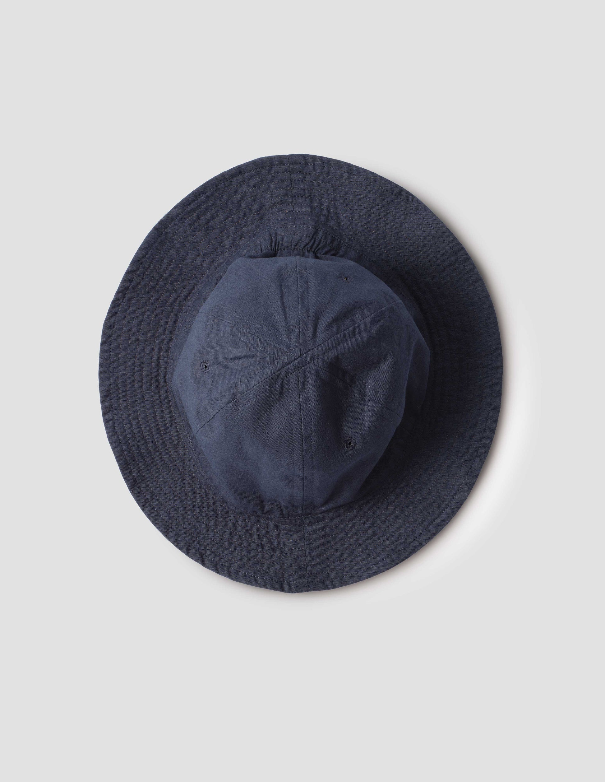 Dark blue cotton hat showing stitching detail on brim. Bird's eye flat lay view.
