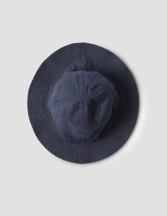 Dark blue cotton hat showing stitching detail on brim. Bird's eye flat lay view.