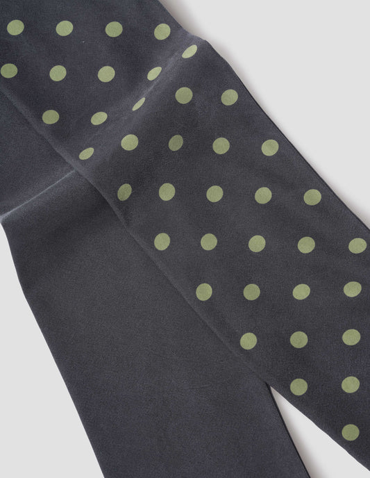 Black silk scarf with light green spots on one side, fabric swatch.