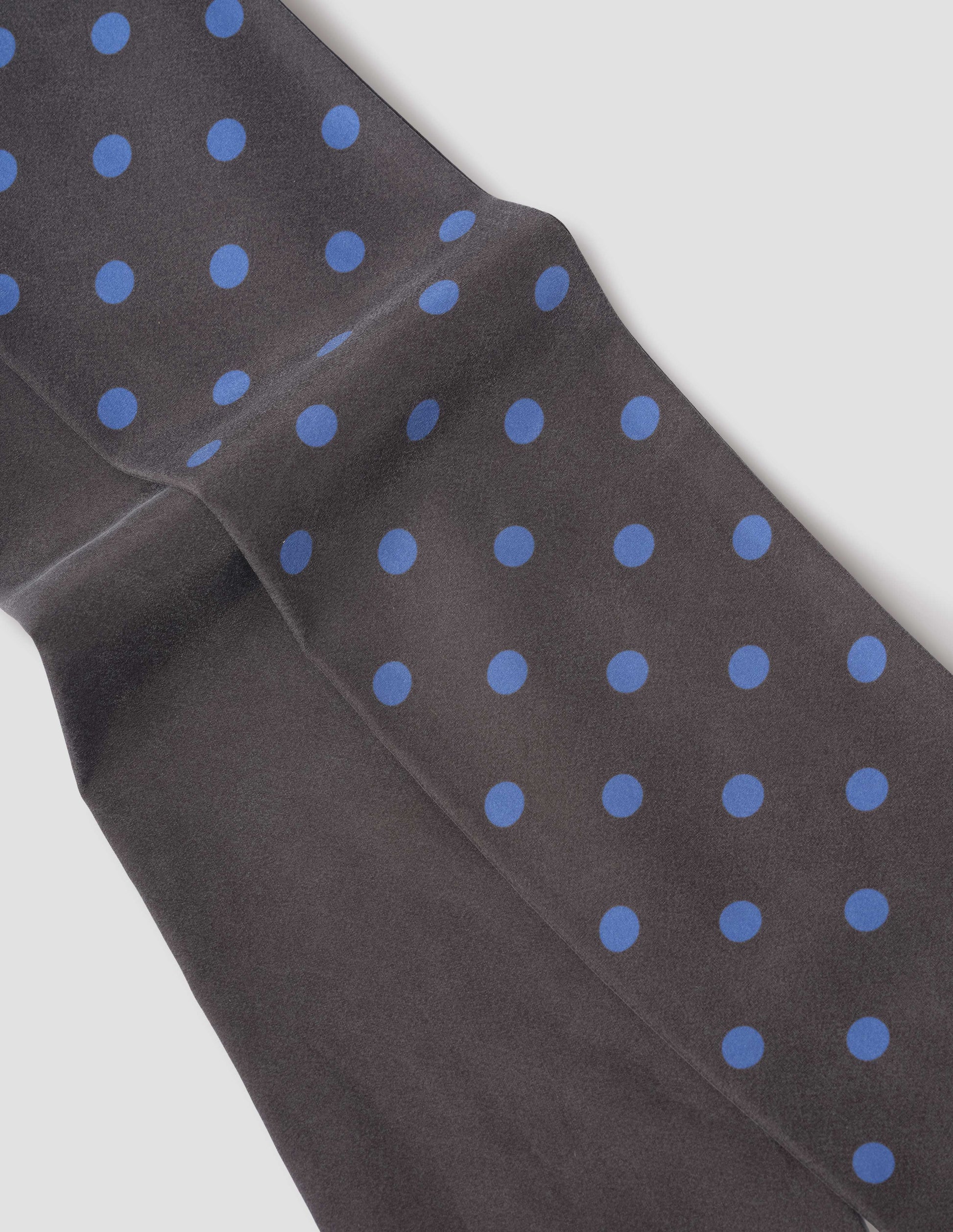 Dark brown silk scarf with blue spots on one side, fabric swatch.