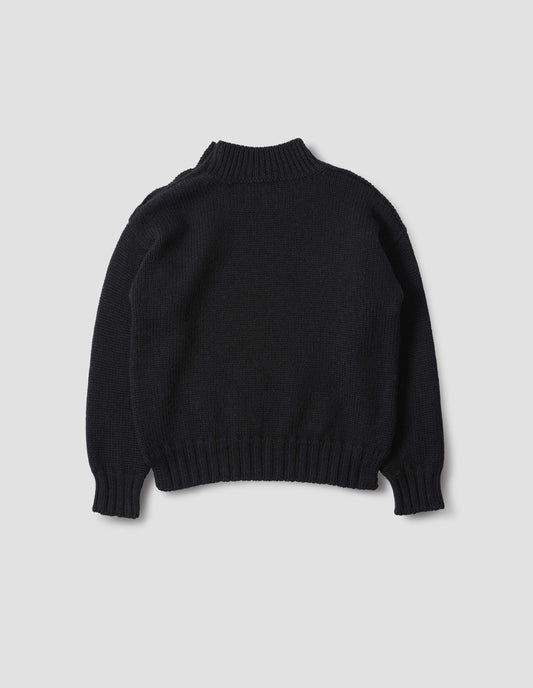 Black high neck jumper with contrast rib on neck, cuffs and hem. Back flat lay view.