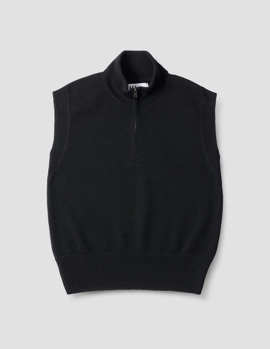 Black wool slipover, with half zip mock turtleneck and flatlock stitch detailing on seams. Front flat lay view.