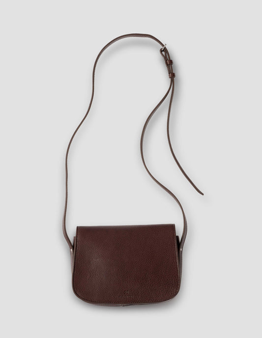 Brown fine grain leather small satchel bag with adjustable shoulder strap. Back flat lay view. 