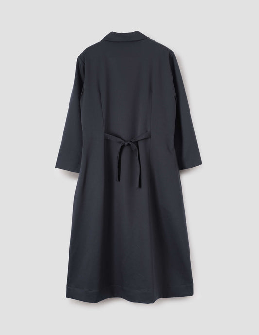 Navy blue collared dress with pintuck detailing, three quarter length sleeves and back tie, back flat lay view.