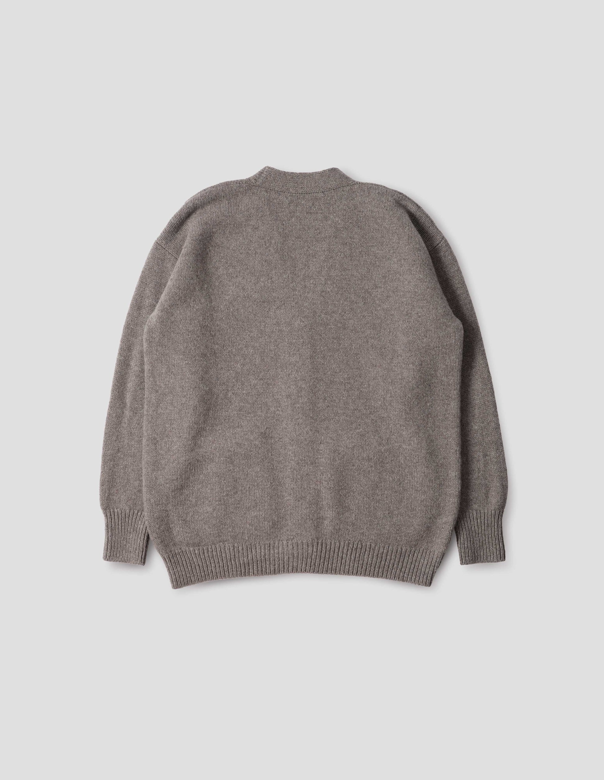 Beige v-neck cardigan, with contrast rib cuffs and hem. Back flat lay view. 