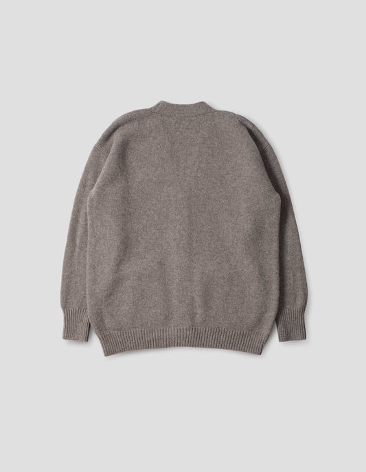 Beige v-neck cardigan, with contrast rib cuffs and hem. Back flat lay view. 