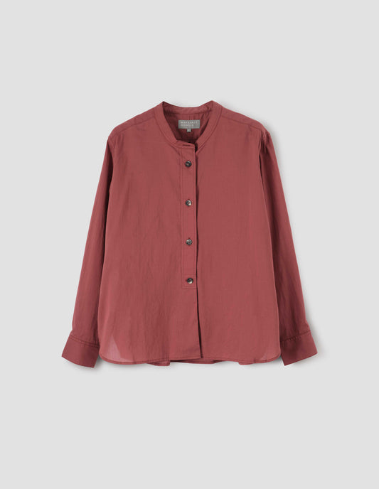 Red pink collarless shirt with raised placket, horn button closure and cuffs, front flat lay view.