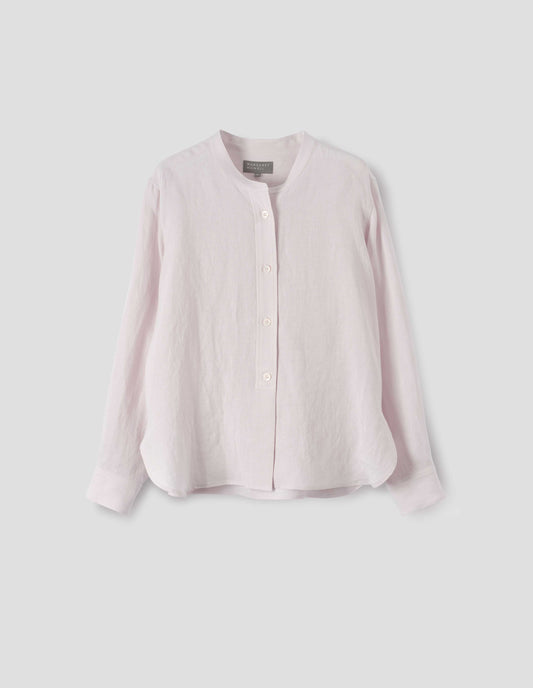 Pinkish beige collarless shirt, with raised placket and mother of pearl buttons. Front flat lay view.