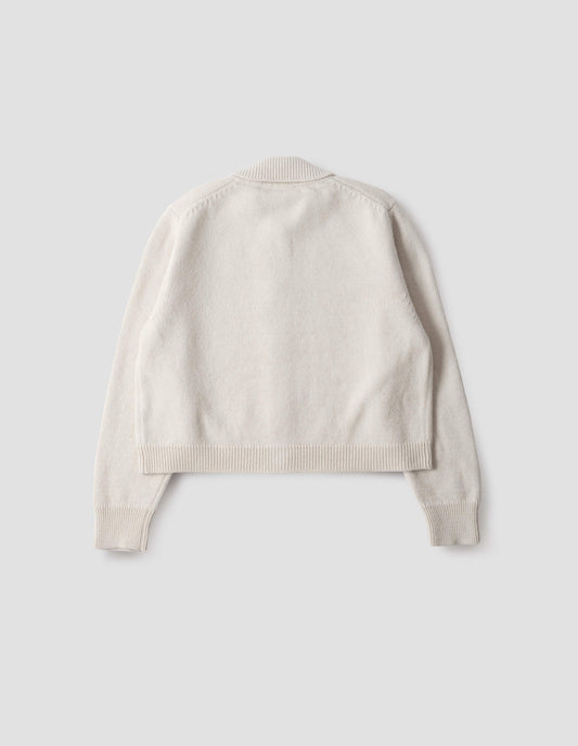 White boxy cardigan with collar, contrast rib on collar, cuffs and hem, back flat lay view.