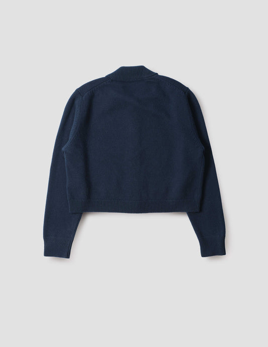 Dark blue boxy cardigan with collar, contrast rib on collar, cuffs and hem, back flat lay view.