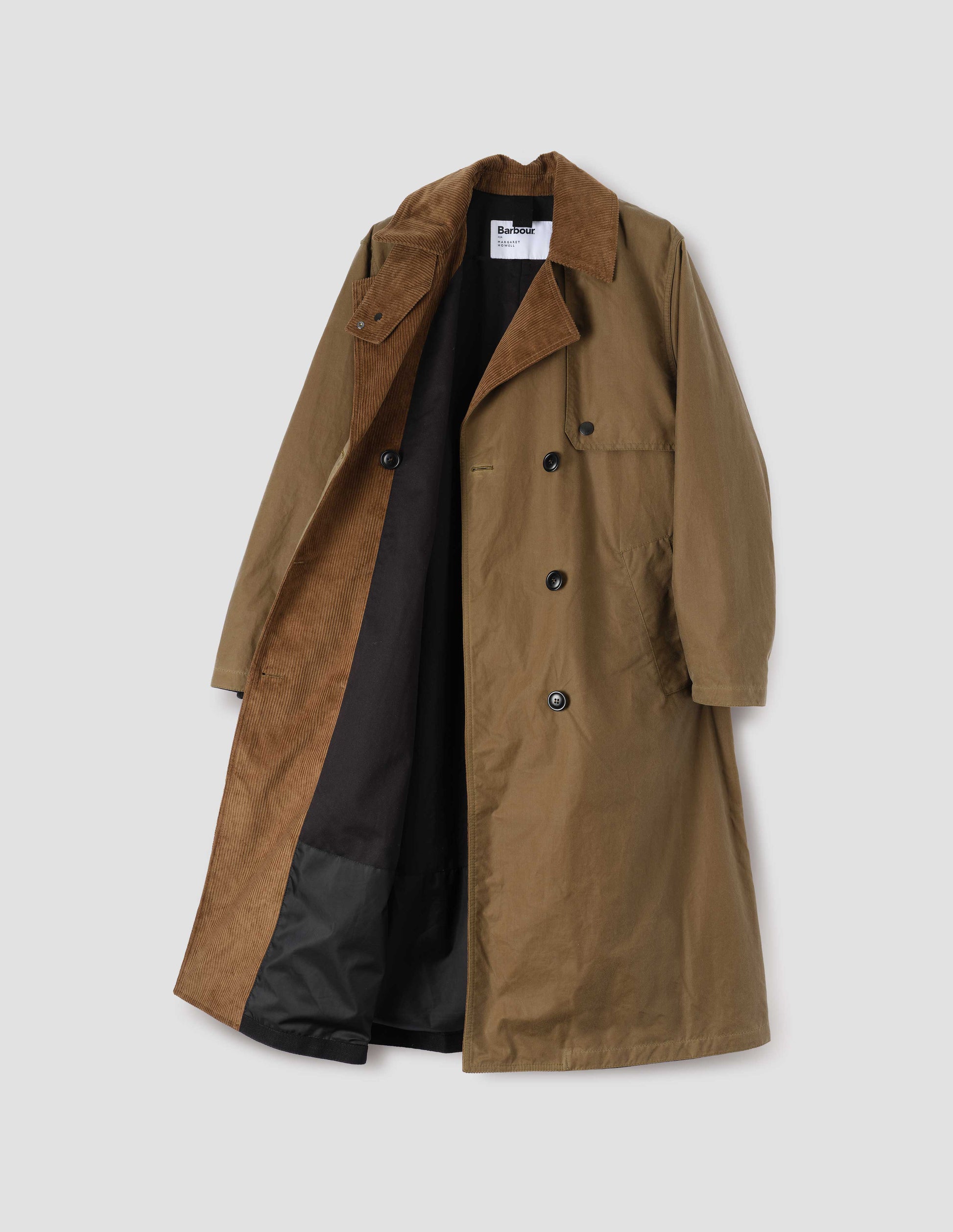 Light brown trench coat with corduroy collar and lapel, cotton drill lining,  press stud fastening storm flap, horn buttons and deep welt slant pockets. Opent flat lay view.