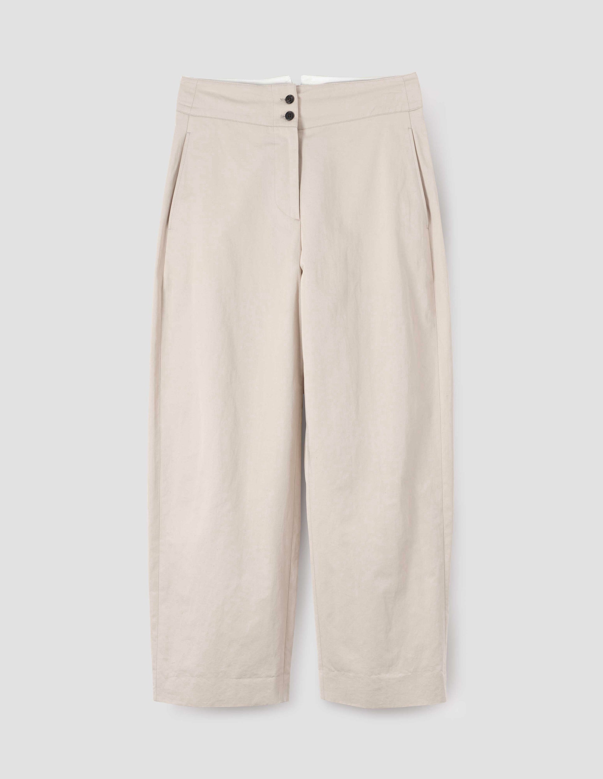 Beige high waisted trousers with black horn buttons and side pockets, front flat lay view. 