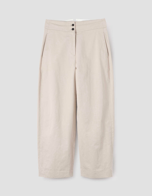 Beige high waisted trousers with black horn buttons and side pockets, front flat lay view. 
