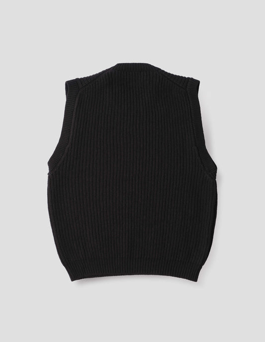 Black sleeveless merino wool slipover, with contrast rib on neck, armhole and hem. Back flat lay view.