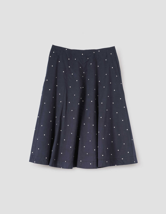 Navy blue and white polka dot flared skirt, with concealed side pockets. Front flat lay view.