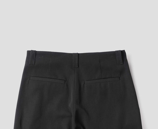 Black wool wide leg culottes, with belt loops, side pockets and welt back pockets. Back flat lay view.