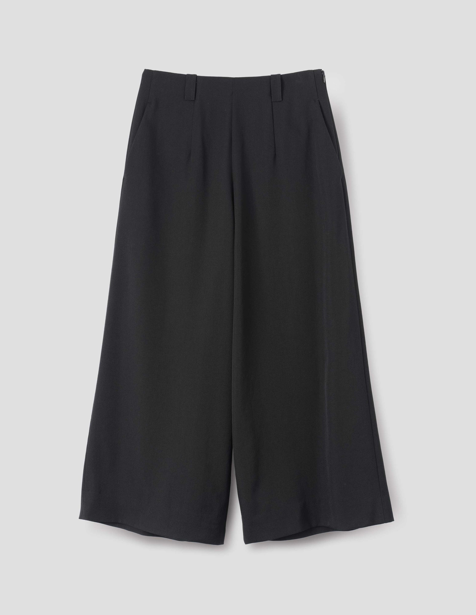Black wool wide leg culottes, with belt loops, side pockets and concealed zip fastening. Front flat lay view.