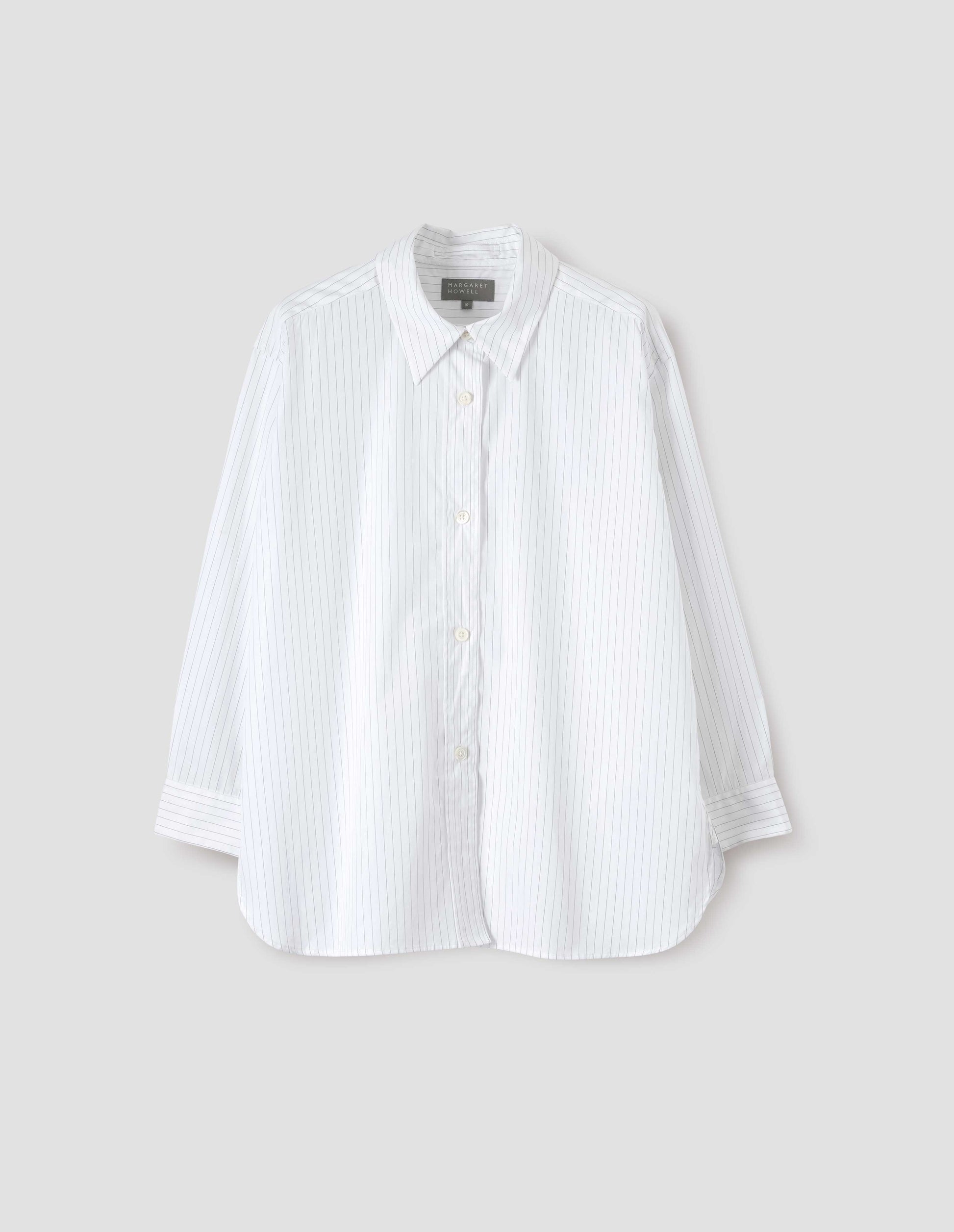 White and grey striped shirt with raised, stitch-through placket with mother of pearl buttons and A line hem. Front flat lay view.