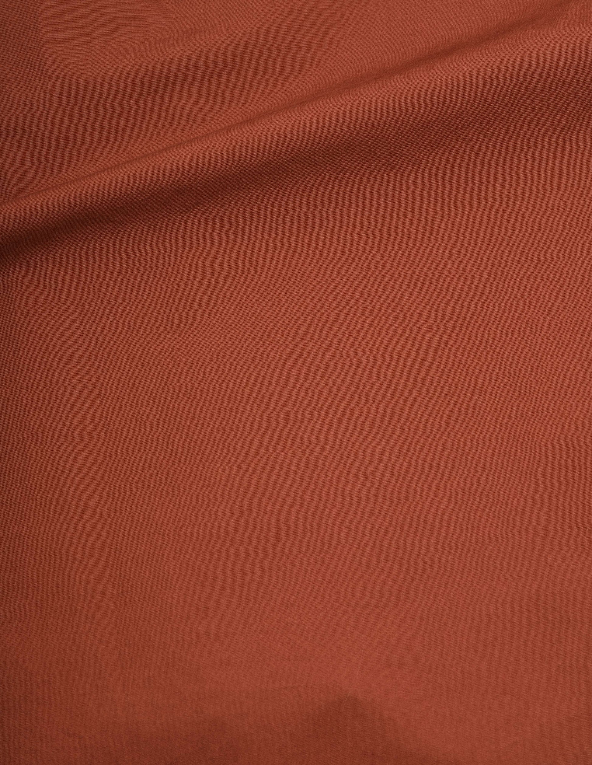 Brownish red washed cotton poplin shirt, fabric swatch. 