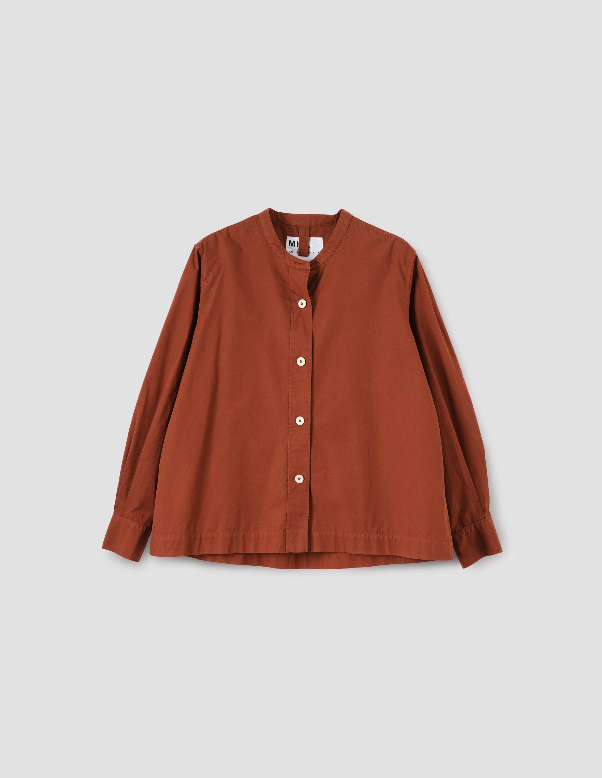 Brownish red collarless shirt with raised stitch through placket and corozo brace buttons. Front flat lay view.