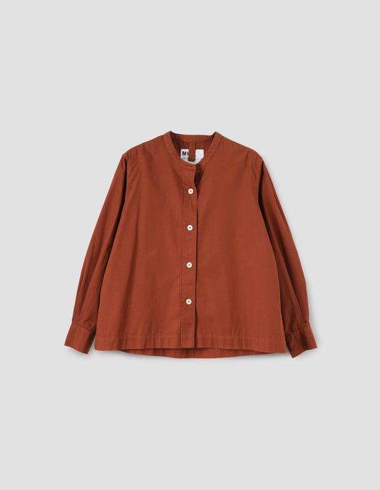 Brownish red collarless shirt with raised stitch through placket and corozo brace buttons. Front flat lay view.