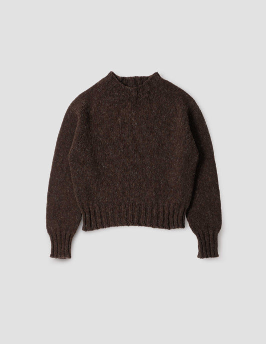 Dark brown rustic wool jumper with saddle sleeve and contrasting rib on neck, cuffs and hem. Front flat lay view.
