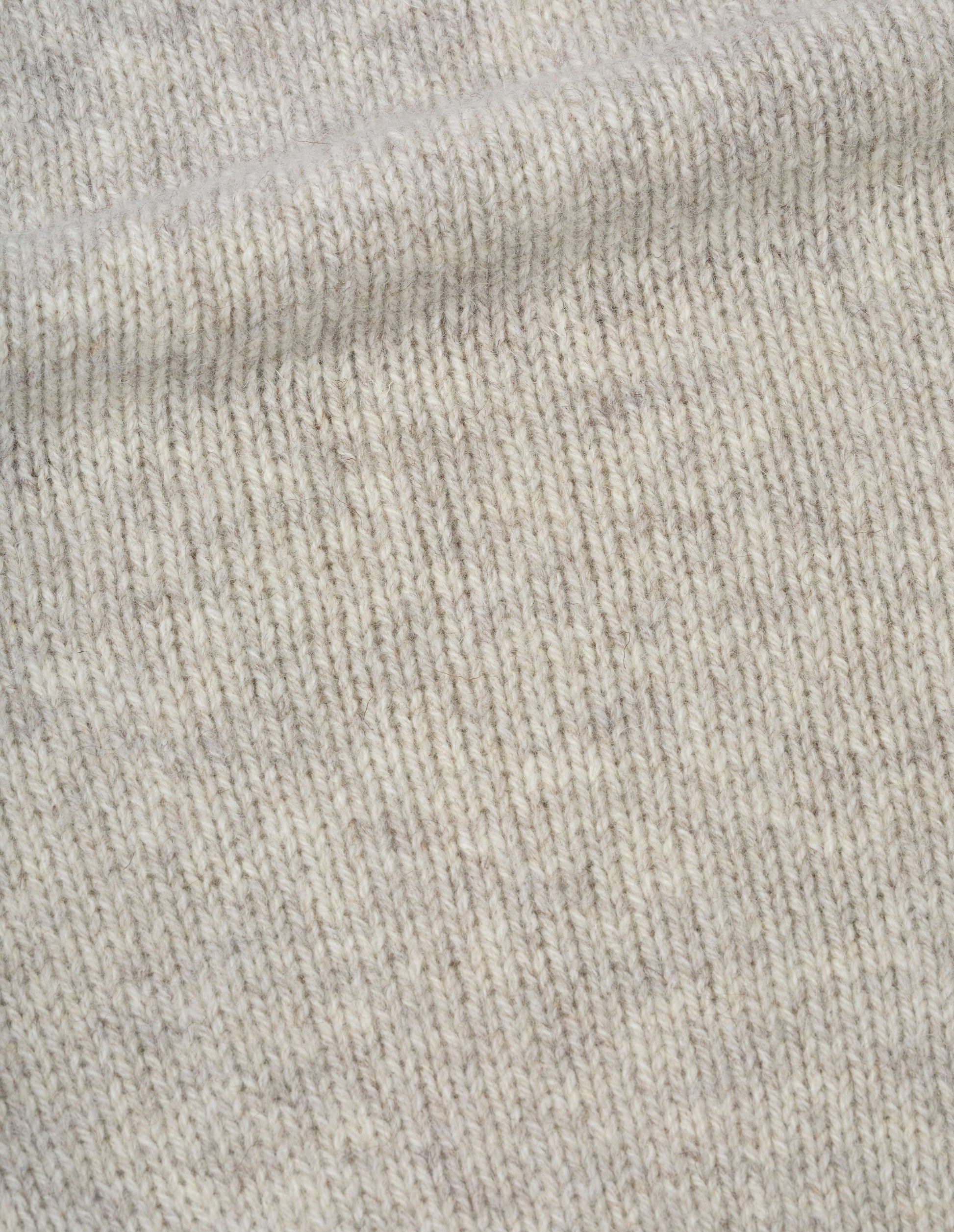 Beige rustic wool jumper, fabric swatch. 